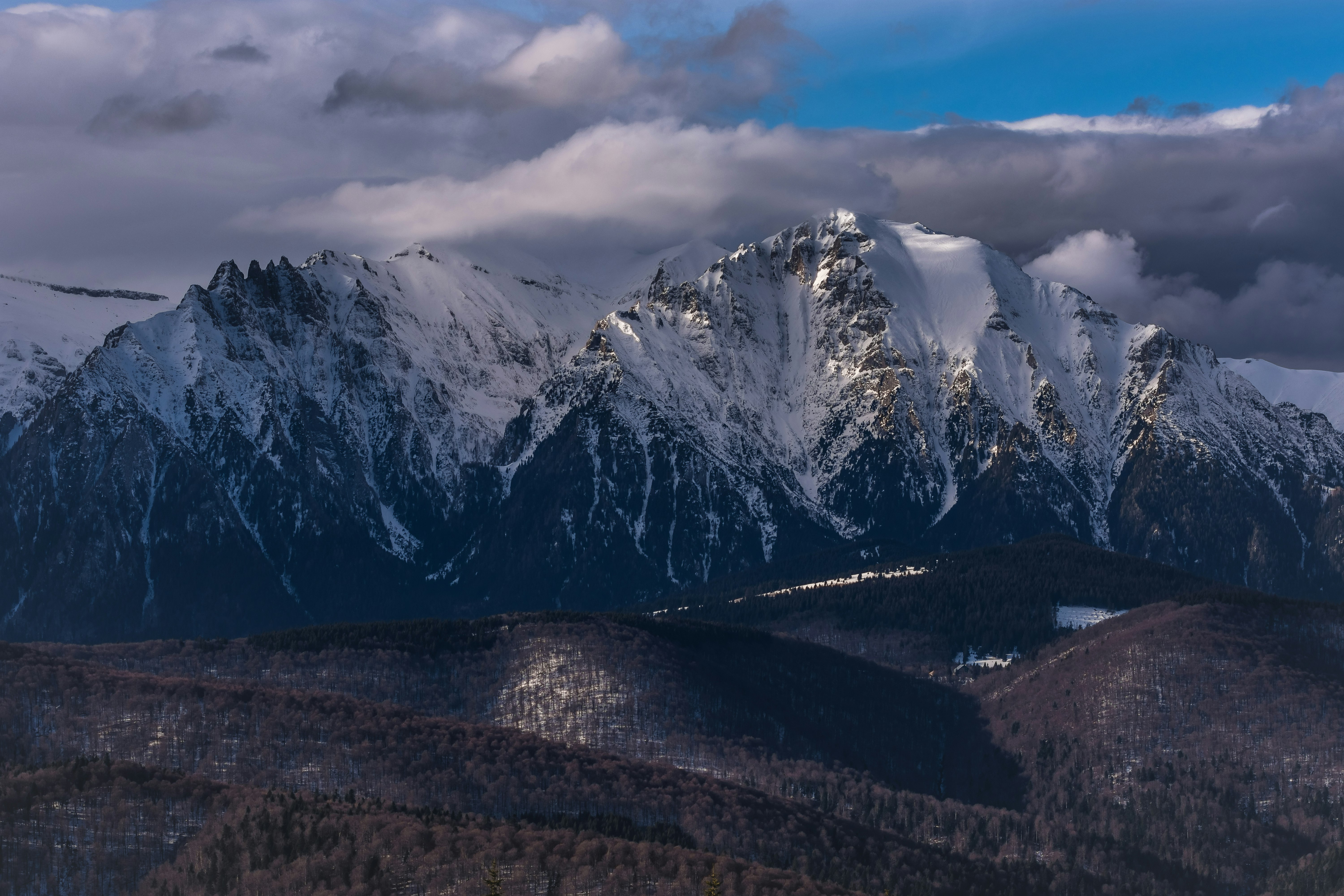 snow-capped mountain under gloomy sky